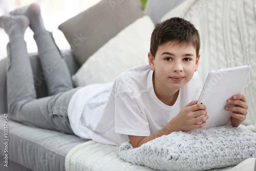 Little boy using tablet on ...