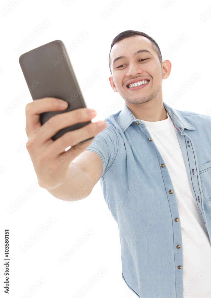 young casual man taking selfie photo using mobilephone young casual man taking selfie photo using mobilephone