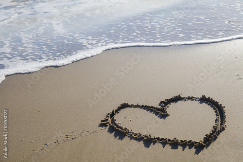 Heart drawn on the sand at the beach