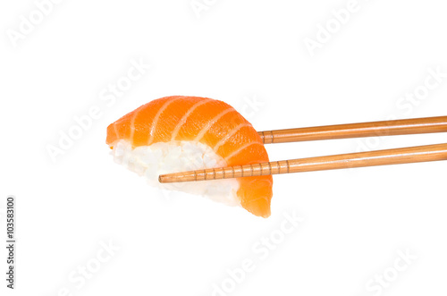 Salmon sushi between two choptsicks islated on white background
