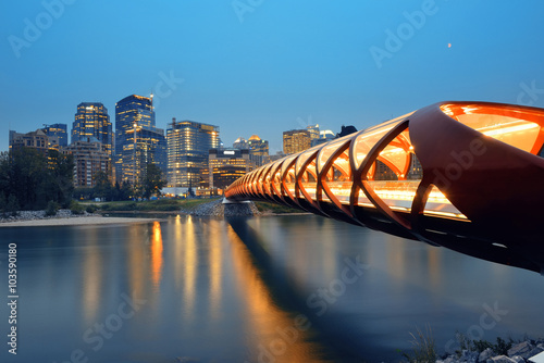 Calgary cityscape with Peace Bridge and downtown skyscrapers in Alberta at dusk, Canada.