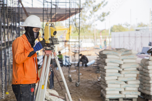 surveyor worker working with equipment at factory construction s © bannafarsai