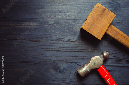 wooden and still hammer on black wooden background