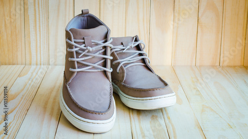 gray suede shoes on wooden background