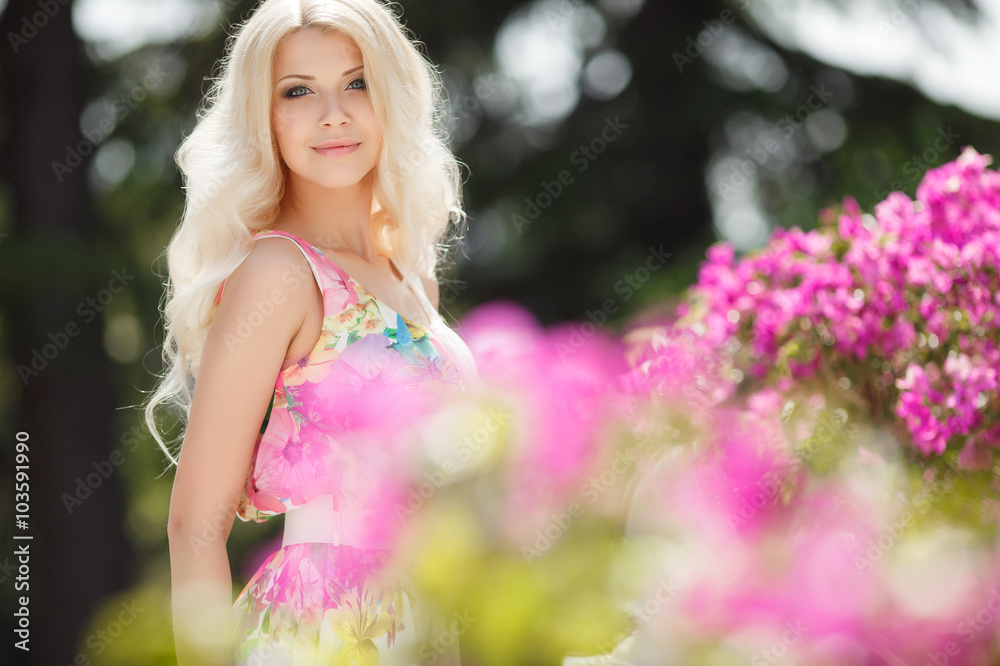 Beautiful woman on the terrace of white with pink flowers