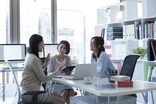 Female company employee teaches work to rookie photo