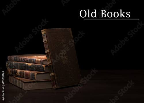 Old books pile on wooden surface. Copyspace for your text.