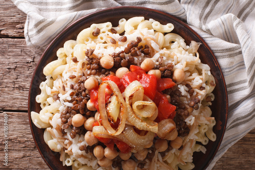 kushari of rice, pasta, chickpeas and lentils close up. horizontal top view
