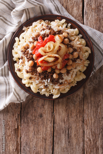 Egyptian kushari of rice, pasta, chickpeas and lentils Vertical top view
