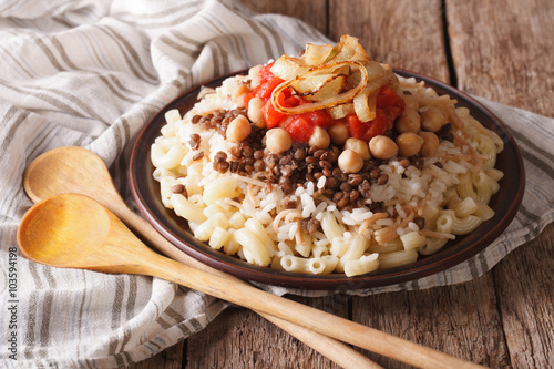 Arabic cuisine: kushari of rice, pasta, chickpeas and lentils close up 
