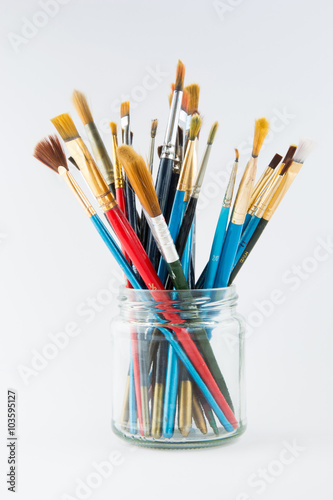 Artist paint brushes in a glass jar