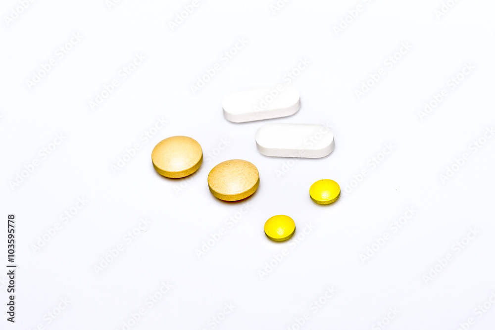 pills white and yellow pills on white background pills white and yellow pills on white background