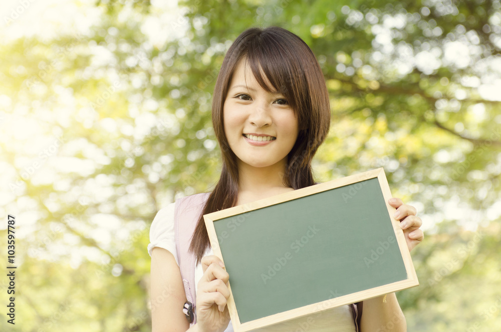 Young Asian college girl student with blank chalkboard Young Asian college girl student with blank chalkboard