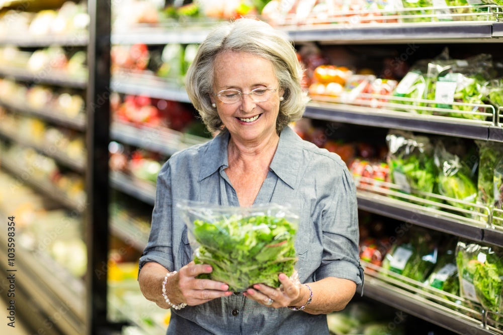 Senior woman picking out some vegetables