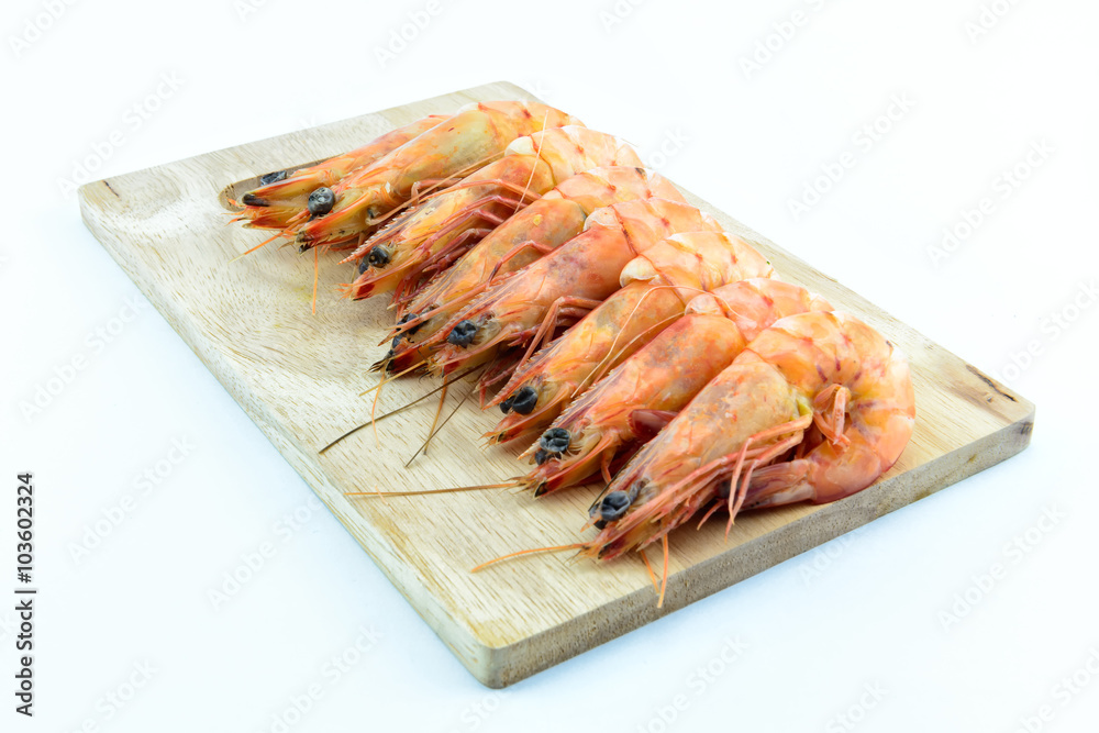 Boiled shrimp on wooden board on white background Boiled shrimp on wooden board on white background