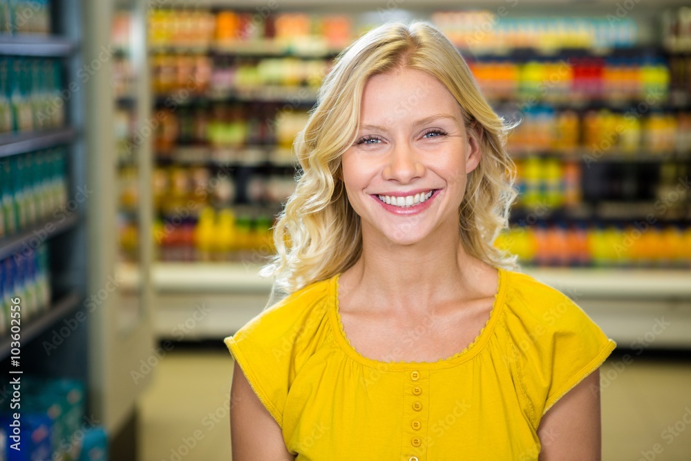 Portrait of smiling woman standing in aisle 