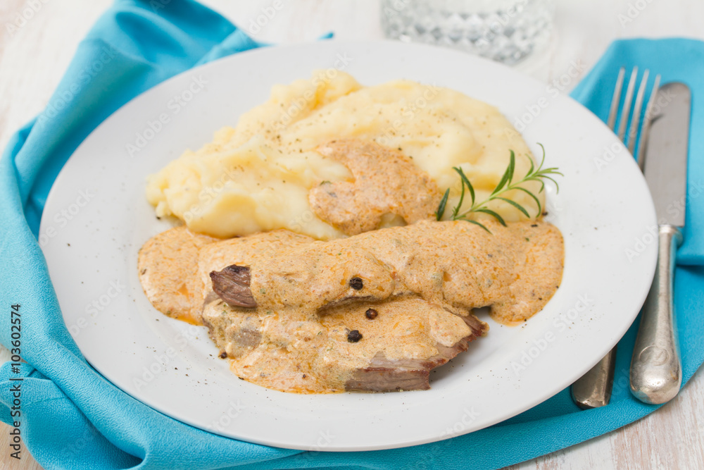 fried pork with sauce and mashed potato on white plate on brown background fried pork with sauce and mashed potato on white plate on brown background