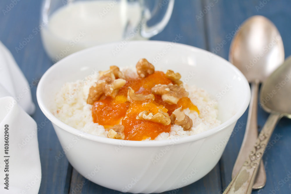 fresh cheese with pumpkin jam and nuts in bowl on blue wooden background fresh cheese with pumpkin jam and nuts in bowl on blue wooden background