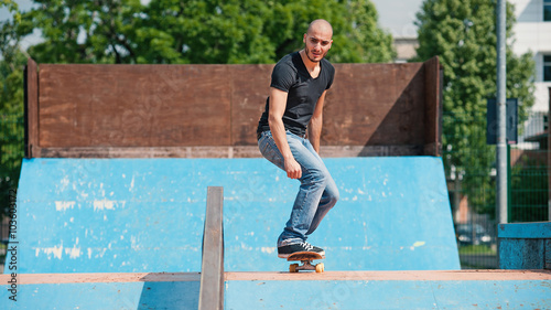 Skateboarder preparing to do a skateboard trick at skate park. © pio3