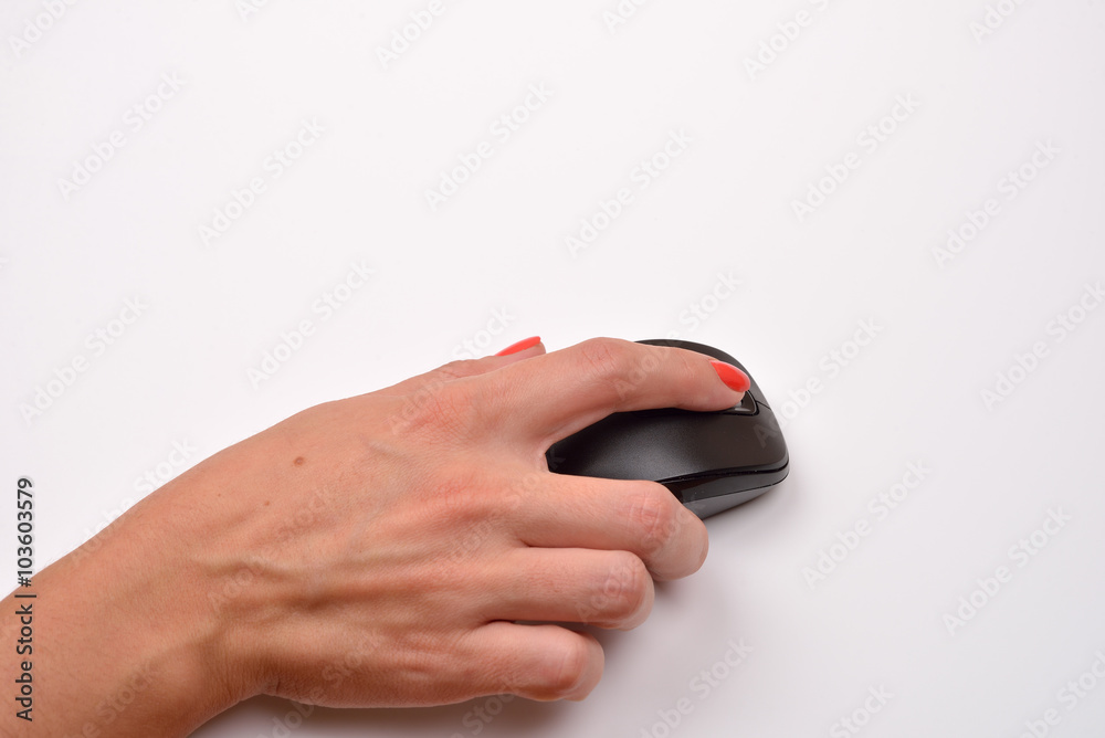 Close-up of a women hand using modern computer mouse on white su Close-up of a women hand using modern computer mouse on white su