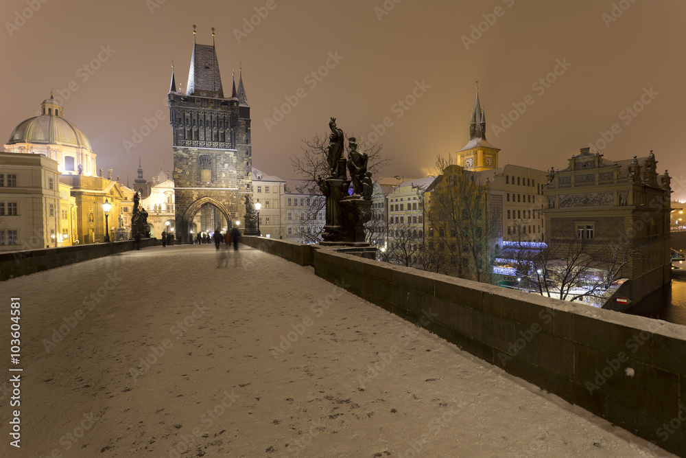 Night romantic snowy Prague Old Town from Charles Bridge with its baroque Sculptures, Czech republic