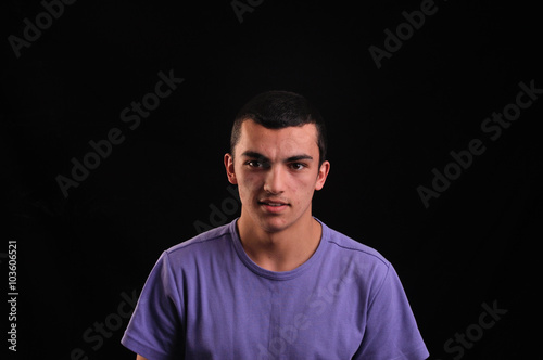Portrait of young man wearing t-shirt looking at camera