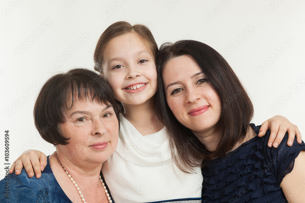 The granddaughter embraces the grandmother and mother The granddaughter embraces the grandmother and mother
