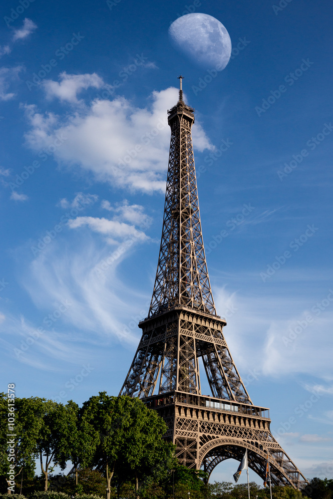 Fototapeta premium Eiffel Tower with large moon in background daytime