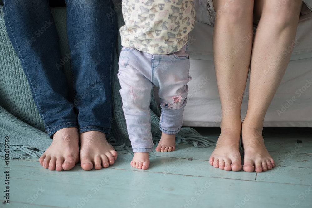Cute newborn foot with family members
