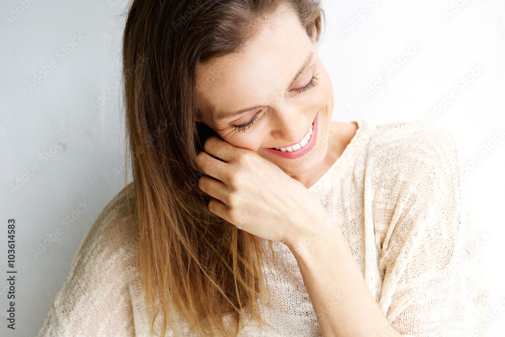 Candid portrait of a woman laughing against white background Candid portrait of a woman laughing against white background