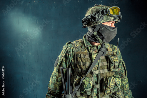 Special forces soldier with rifle on dark background

