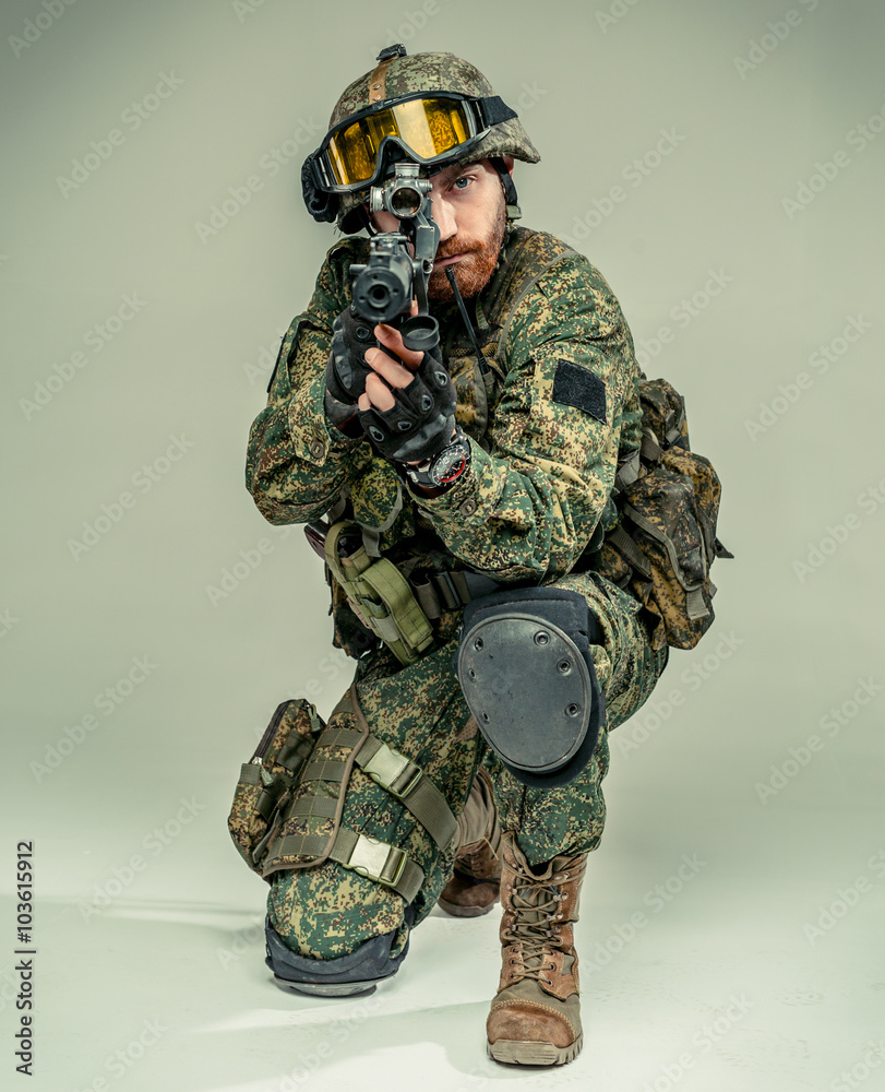 Special forces soldier with rifle on grey background Special forces soldier with rifle on grey background