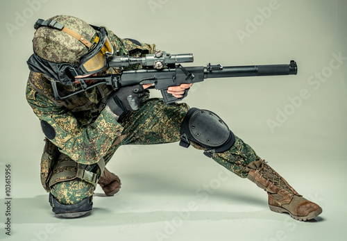 Bilde på lerret Special forces soldier with rifle on grey background