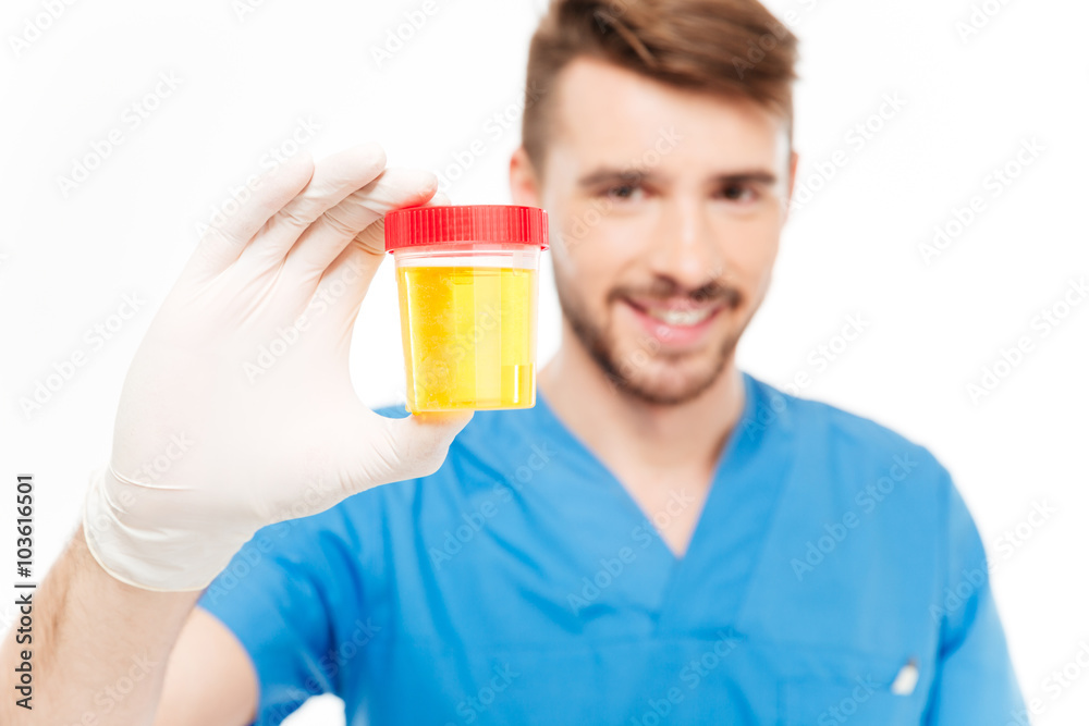 Male doctor holding bottle of urine sample Male doctor holding bottle of urine sample