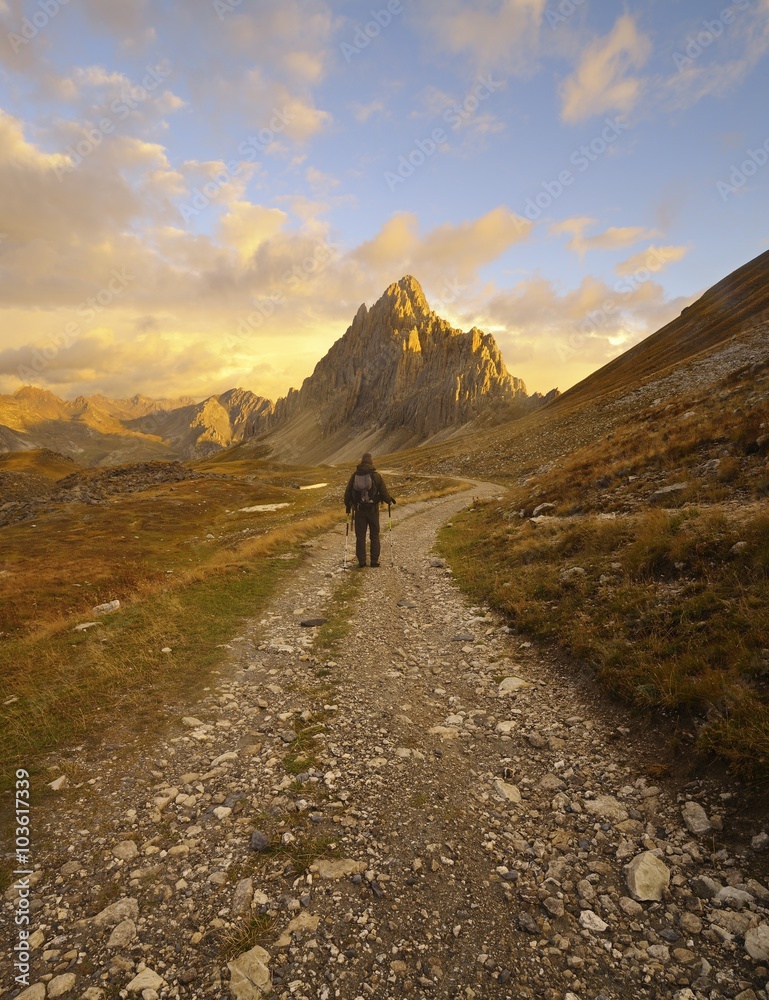 Hiker on a beautiful road in the mountains, Rocca la Meja, italian Alps