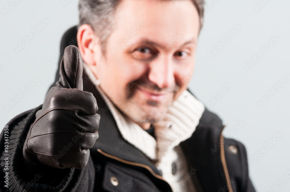 Closeup of attractive man thumb up and smile Closeup of attractive man thumb up and smile