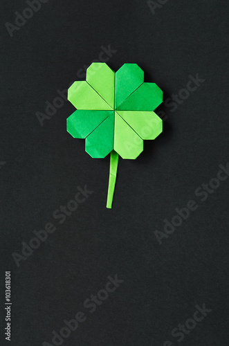 Green origami shamrock clover leaf paper background. St. Patrick's Day greeting postcard template. Space for copy, text, lettering.
