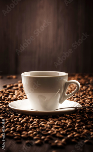 Cup of coffee on beans background