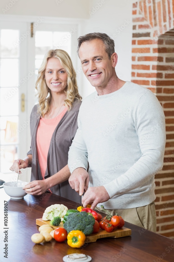 Cute couple slicing vegetables