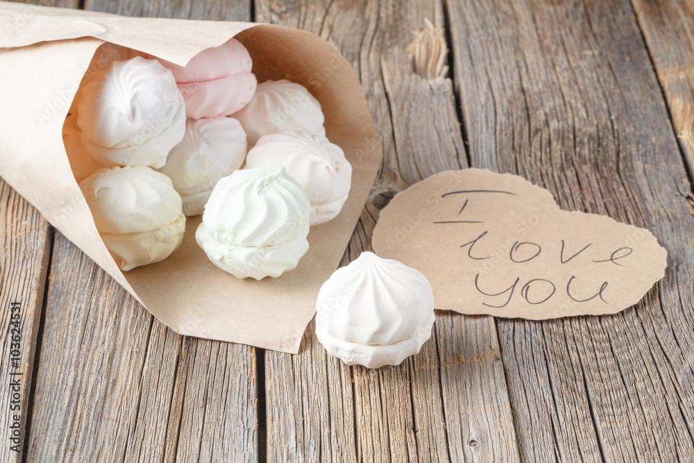 Love message concept, sweets and heart on rustic table Love message concept, sweets and heart on rustic table