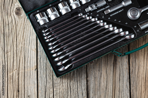 Tools in box on wooden background