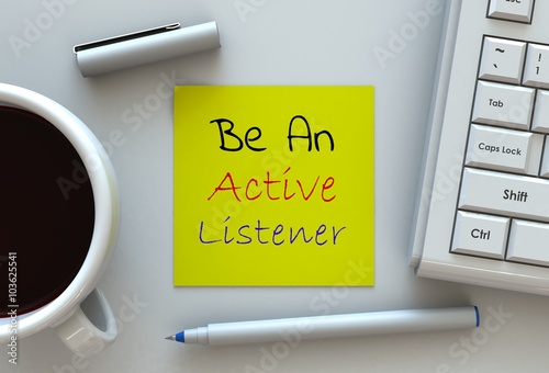 Be An Active Listener, message on note paper, computer and coffee on table
