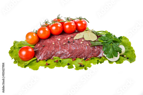 A piece of raw beef meat on lettuce isolated on white background