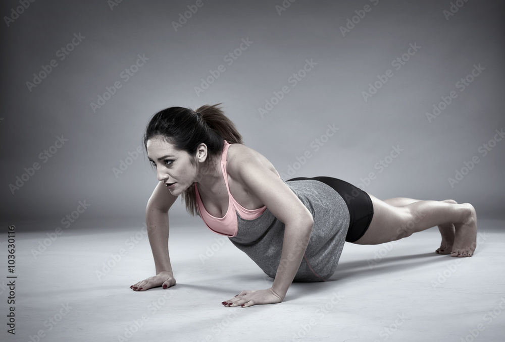 Athletic girl doing pushups Athletic girl doing pushups