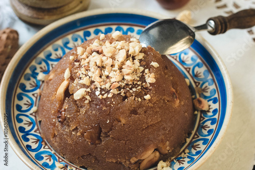 
semolina halva, halvah, halava sweet desert with raisiins and nuts photo