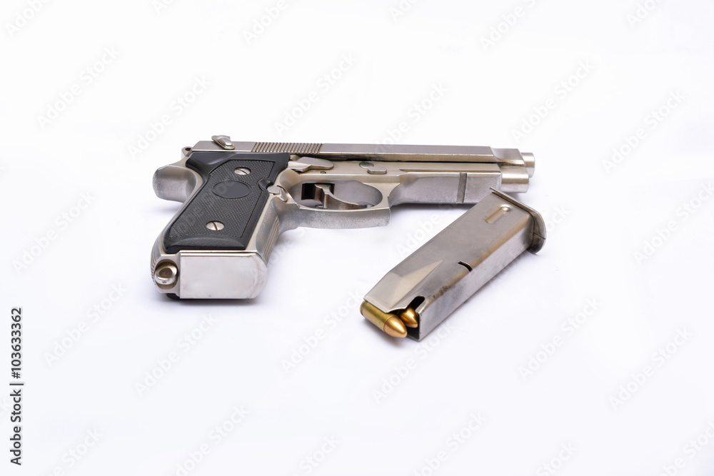Automatic handgun pistol with magazine and bullets on white background Automatic handgun pistol with magazine and bullets on white background