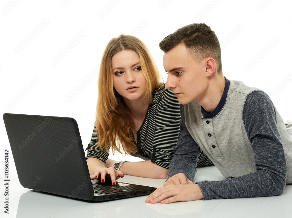 Teenagers doing homework together on a laptop Teenagers doing homework together on a laptop