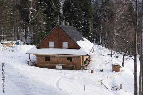 house under construction in the mountains in the snow in the woods © lapis2380