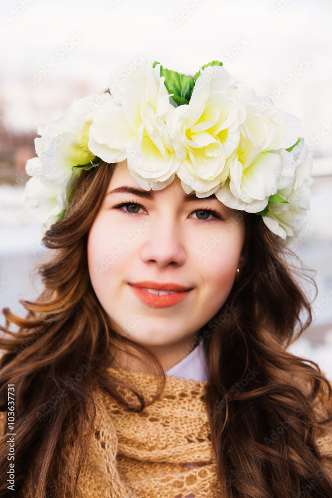 Beautiful young girl with a floral ornament in her hair Beautiful young girl with a floral ornament in her hair