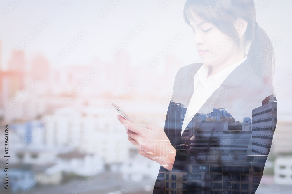 double exposure of business woman using smart phone with blur city double exposure of business woman using smart phone with blur city